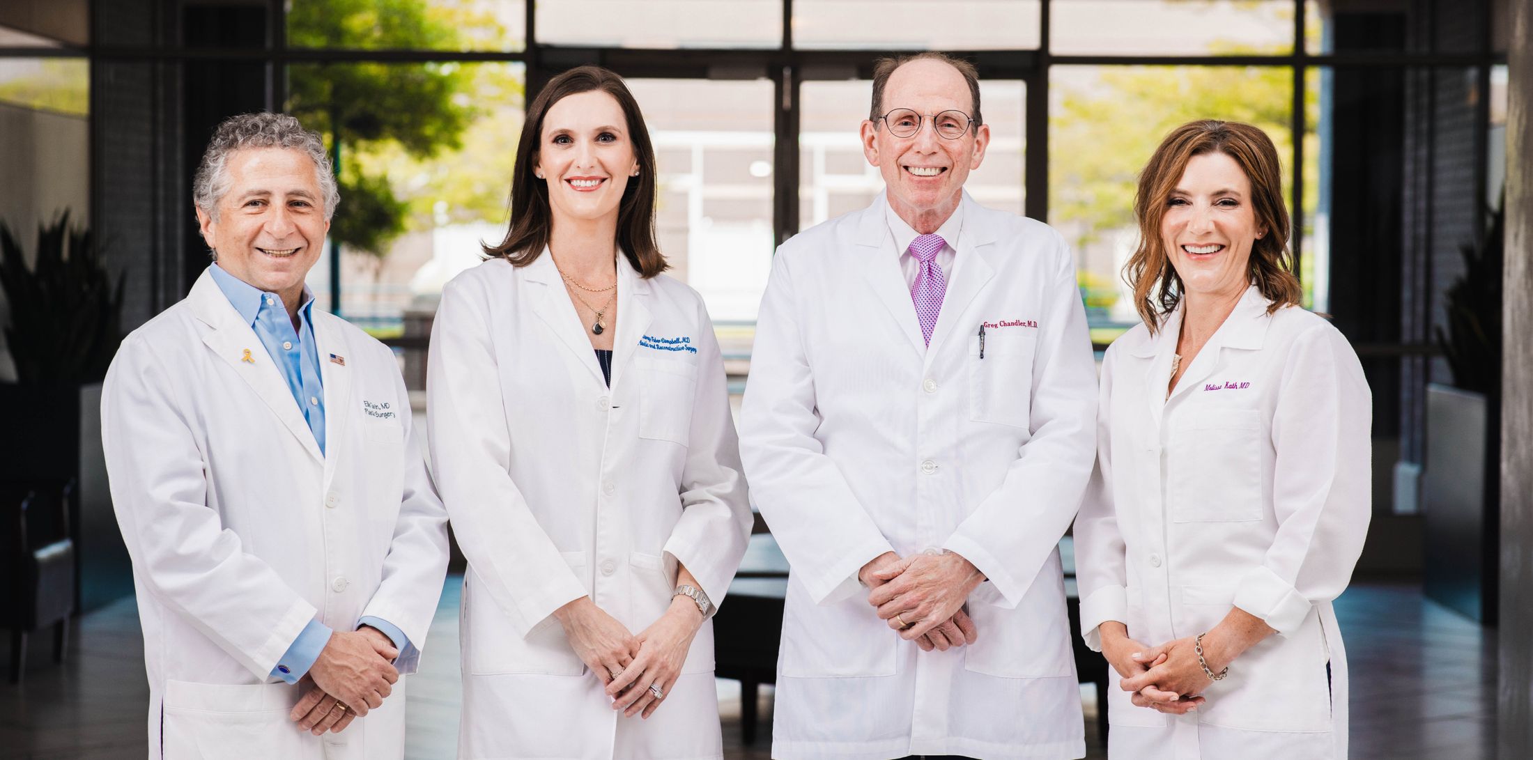 plastic surgery group of memphis staff in front of their doors