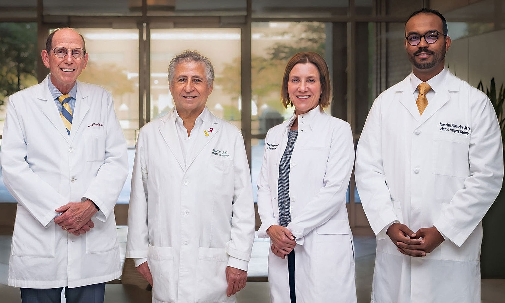 Four medical professionals in white lab coats.
